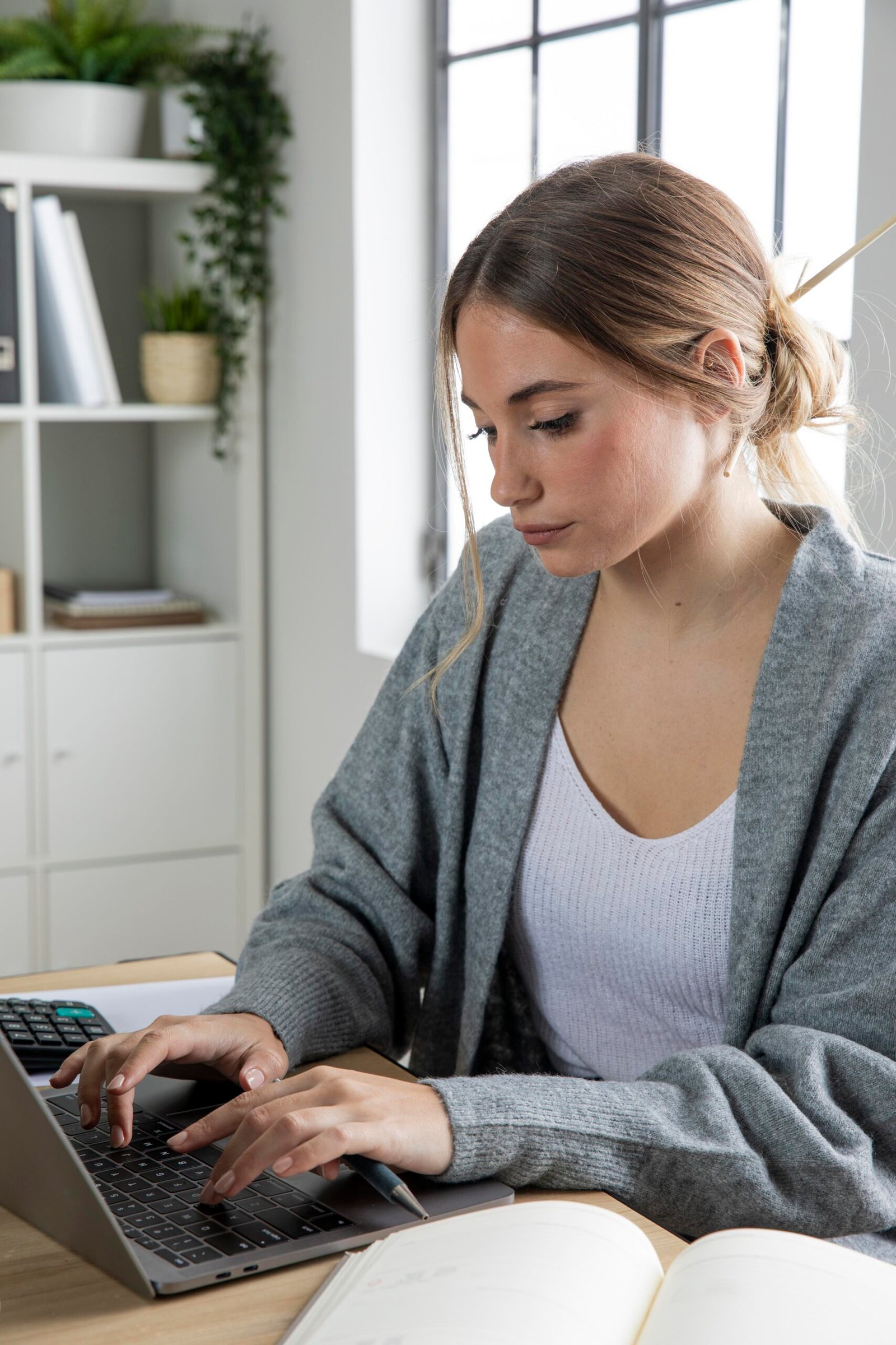 Joven autónomo trabajando con software de facturación electrónica en su portátil desde casa
